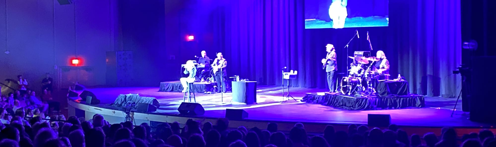 signer on stage in chair washed out by the lights Columbus